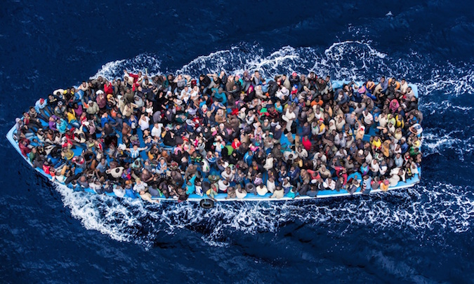 A boatload of refugees rescued 20 miles north of Libya by the Italian Navy during Operation