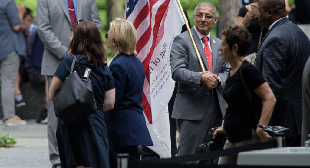 Hillary Clinton leaves a memorial service at the National 9/11 Memorial in New York after feeling "overheated." | Getty