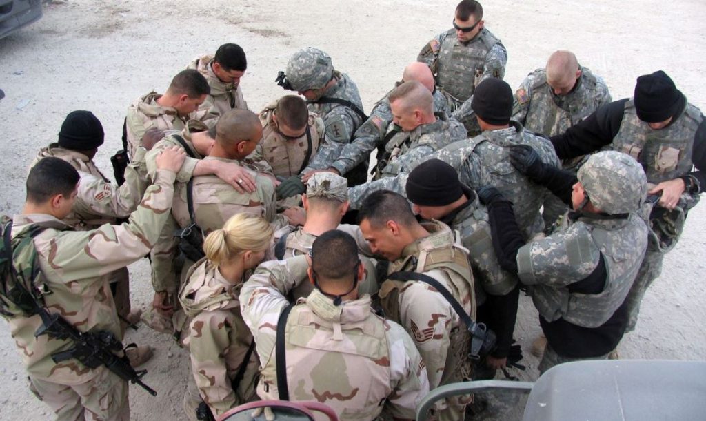 SOUTHWEST ASIA -- The convoy members and their Army gun truck escorts take a moment to pray for each other's safety before beginning the day's convoy mission. (U.S. Air Force photo)